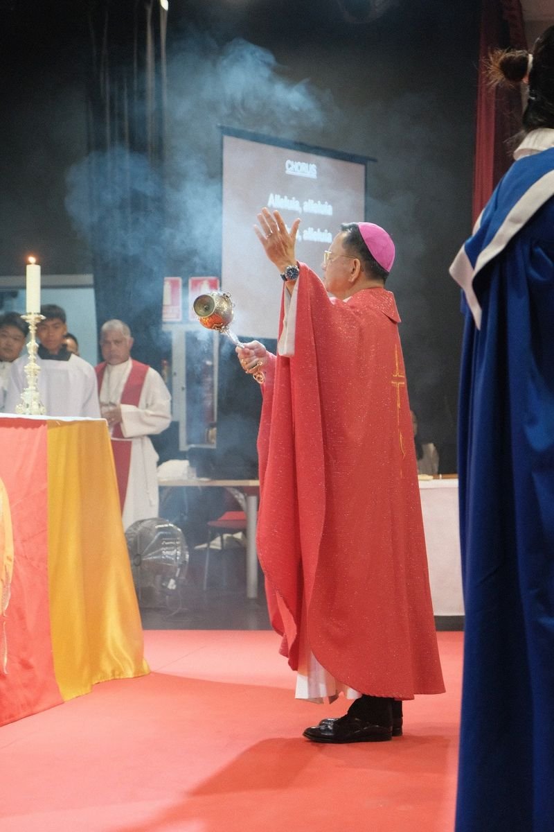 A bishop censing the altar during Mass